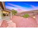 Backyard featuring easy care desert landscaping, a covered patio and beautiful plants at 1643 Silver Slipper Ave, Henderson, NV 89002