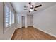 Bedroom featuring wood-look tile, double closets, and bright, natural light at 1643 Silver Slipper Ave, Henderson, NV 89002