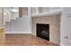 Living room fireplace with decorative tile and hardwood flooring at 1643 Silver Slipper Ave, Henderson, NV 89002