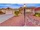 Inviting single-story home featuring desert landscaping and a decorative rock stream in the front yard at 1643 Silver Slipper Ave, Henderson, NV 89002