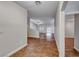 Bright hallway with wood-look flooring leading to a spacious living area and additional rooms at 1643 Silver Slipper Ave, Henderson, NV 89002