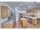 Bright kitchen with stainless steel appliances, island, and light wood cabinetry at 1643 Silver Slipper Ave, Henderson, NV 89002