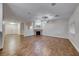 Open living room with wood-look floors, a cozy fireplace, and ample natural light from a window at 1643 Silver Slipper Ave, Henderson, NV 89002