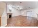 Spacious living room with wood-look floors, a ceiling fan, and a sliding glass door at 1643 Silver Slipper Ave, Henderson, NV 89002