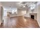 Expansive living room featuring an open-concept design, wood-look floors, and a cozy fireplace at 1643 Silver Slipper Ave, Henderson, NV 89002