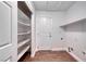 Walk-in pantry features organized shelving, wood-look floors, and a convenient laundry hookup at 1643 Silver Slipper Ave, Henderson, NV 89002