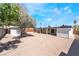 Large backyard featuring gravel, privacy fencing, trees, and two shed structures at 1700 Sweeney Ave, Las Vegas, NV 89104