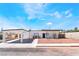 Charming single story home with a covered carport, desert landscaping, and black trimmed windows at 1700 Sweeney Ave, Las Vegas, NV 89104