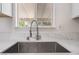 Close-up of a stainless steel sink with a pull-down faucet and marble countertops at 1700 Sweeney Ave, Las Vegas, NV 89104