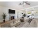 Bright living room featuring a stone fireplace, ceiling fan, and an open floorplan at 1700 Sweeney Ave, Las Vegas, NV 89104