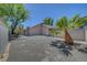 Private backyard featuring desert landscaping, mature trees, and a block wall for privacy at 1705 Westwind Rd, Las Vegas, NV 89146