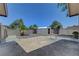 Spacious backyard featuring a storage shed, mature trees, and a partially paved area at 1705 Westwind Rd, Las Vegas, NV 89146
