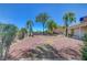 Expansive backyard with decorative rock ground cover, mature trees, and privacy hedges at 1705 Westwind Rd, Las Vegas, NV 89146