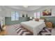 Well-staged bedroom features natural light, a patterned rug, and clean decor at 1705 Westwind Rd, Las Vegas, NV 89146