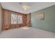 Cozy dining room featuring a brick accent wall, large window, and neutral carpet at 1705 Westwind Rd, Las Vegas, NV 89146