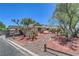 Property shows a covered carport and driveway, with mature trees, and desert landscaping, in a desirable location at 1705 Westwind Rd, Las Vegas, NV 89146