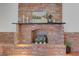 Close-up of a traditional brick fireplace with a decorative mantle, adding character to the living space at 1705 Westwind Rd, Las Vegas, NV 89146