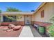 Welcoming facade featuring desert landscaping, a covered entryway, and mature trees, creating an inviting curb appeal at 1705 Westwind Rd, Las Vegas, NV 89146