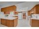 Bright kitchen features wood cabinets, white countertops, tiled floors, and modern appliances at 1705 Westwind Rd, Las Vegas, NV 89146