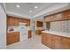 Bright kitchen features wood cabinets, white countertops, tiled floors, and modern appliances at 1705 Westwind Rd, Las Vegas, NV 89146