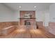 Spacious living room featuring hardwood floors, brick accents, and a cozy fireplace at 1705 Westwind Rd, Las Vegas, NV 89146