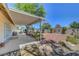 Covered back patio offering outdoor living space and decorative rock landscaping at 1705 Westwind Rd, Las Vegas, NV 89146