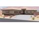 Charming single-story home featuring desert landscaping, three-car garage, and neutral color palette at 1840 Old West Ave, Pahrump, NV 89048