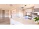 Spacious kitchen with white cabinets, marble countertops, an island, stainless steel appliances and bar seating at 1840 Old West Ave, Pahrump, NV 89048