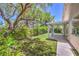 Beautiful backyard including artificial grass, a covered patio, and mature shade trees at 1869 Desert Forest Way, Henderson, NV 89012