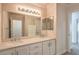 Well-lit bathroom featuring a double sink vanity with marble countertop and decorative wallpaper at 1869 Desert Forest Way, Henderson, NV 89012