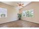 Bright bedroom featuring new flooring, a ceiling fan, and large windows with great natural light at 1869 Desert Forest Way, Henderson, NV 89012