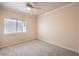 Neutral bedroom featuring a ceiling fan, a window with blinds, and neutral carpeting at 1869 Desert Forest Way, Henderson, NV 89012