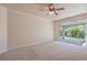 Light filled bedroom with carpet flooring and sliding glass doors that lead to a patio and backyard at 1869 Desert Forest Way, Henderson, NV 89012