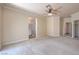 Large bedroom with carpet flooring, ceiling fan, crown molding, and an ensuite bathroom at 1869 Desert Forest Way, Henderson, NV 89012