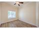 Cozy bedroom featuring hardwood floors, a ceiling fan and a bright sunny window at 1869 Desert Forest Way, Henderson, NV 89012