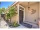 Inviting front door with decorative ironwork, a hanging lantern, and climbing plants at 1869 Desert Forest Way, Henderson, NV 89012