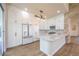 Modern kitchen with white cabinets, stainless steel appliances, and a stylish stone accent wall at 1869 Desert Forest Way, Henderson, NV 89012