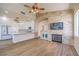 Beautiful living space, flowing into a modern kitchen with an elegant stone fireplace wall feature at 1869 Desert Forest Way, Henderson, NV 89012