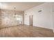 Spacious living room features wood-look floors, stone details, and abundant natural light at 1869 Desert Forest Way, Henderson, NV 89012