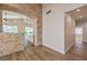 Open-concept living room with stone archway, seamlessly blending charm and sophistication at 1869 Desert Forest Way, Henderson, NV 89012