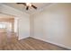 A bright living room featuring hardwood floors and a view into the open kitchen at 1869 Desert Forest Way, Henderson, NV 89012