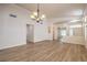Bright, open living room features wood floors and a decorative chandelier at 1869 Desert Forest Way, Henderson, NV 89012