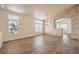 Spacious living room featuring hardwood floors, brick accent wall and many bright sunny windows at 1869 Desert Forest Way, Henderson, NV 89012