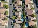 A bird's eye view of the neighborhood, highlighting the homes and community pools at 1870 Desert Forest Way, Henderson, NV 89012