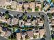 A high angle view of an upscale residential neighborhood with manicured lawns and private pools at 1870 Desert Forest Way, Henderson, NV 89012