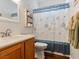 Cozy bathroom features a stylish vanity and shower with floral curtain at 1870 Desert Forest Way, Henderson, NV 89012