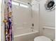 Well-lit bathroom featuring a tub-shower combo, white tile, and simple fixtures at 1870 Desert Forest Way, Henderson, NV 89012