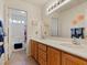 Bright bathroom features a double sink vanity and a view of the shower through the doorway at 1870 Desert Forest Way, Henderson, NV 89012