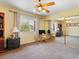 A bedroom with a window, mirrored closet, carpet floors, and ceiling fan at 1870 Desert Forest Way, Henderson, NV 89012