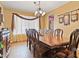 Formal dining room featuring wood floors, elegant chandelier, and matching furniture at 1870 Desert Forest Way, Henderson, NV 89012